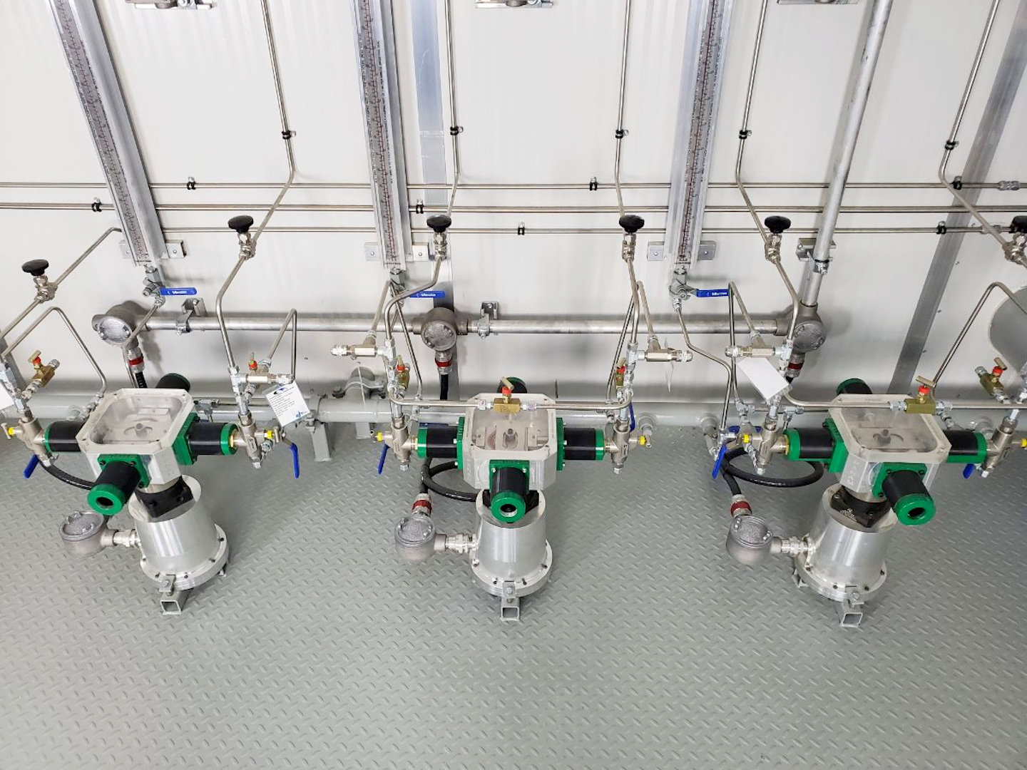 Three CROSSFIRE low power solar chemical injection pumps lined up
